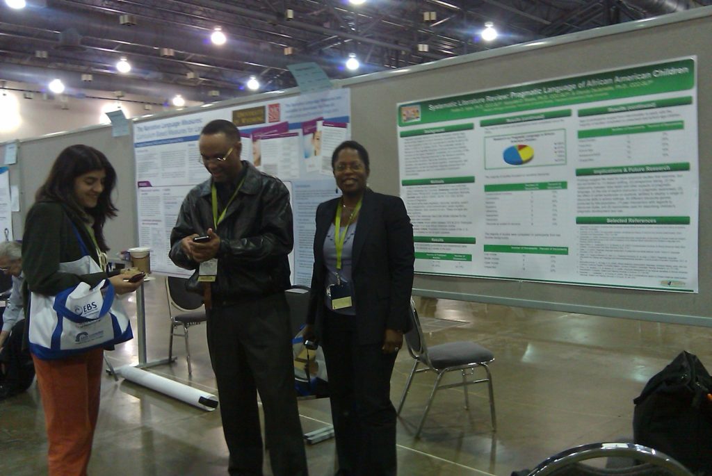 Photo of the team presenting at a poster session.